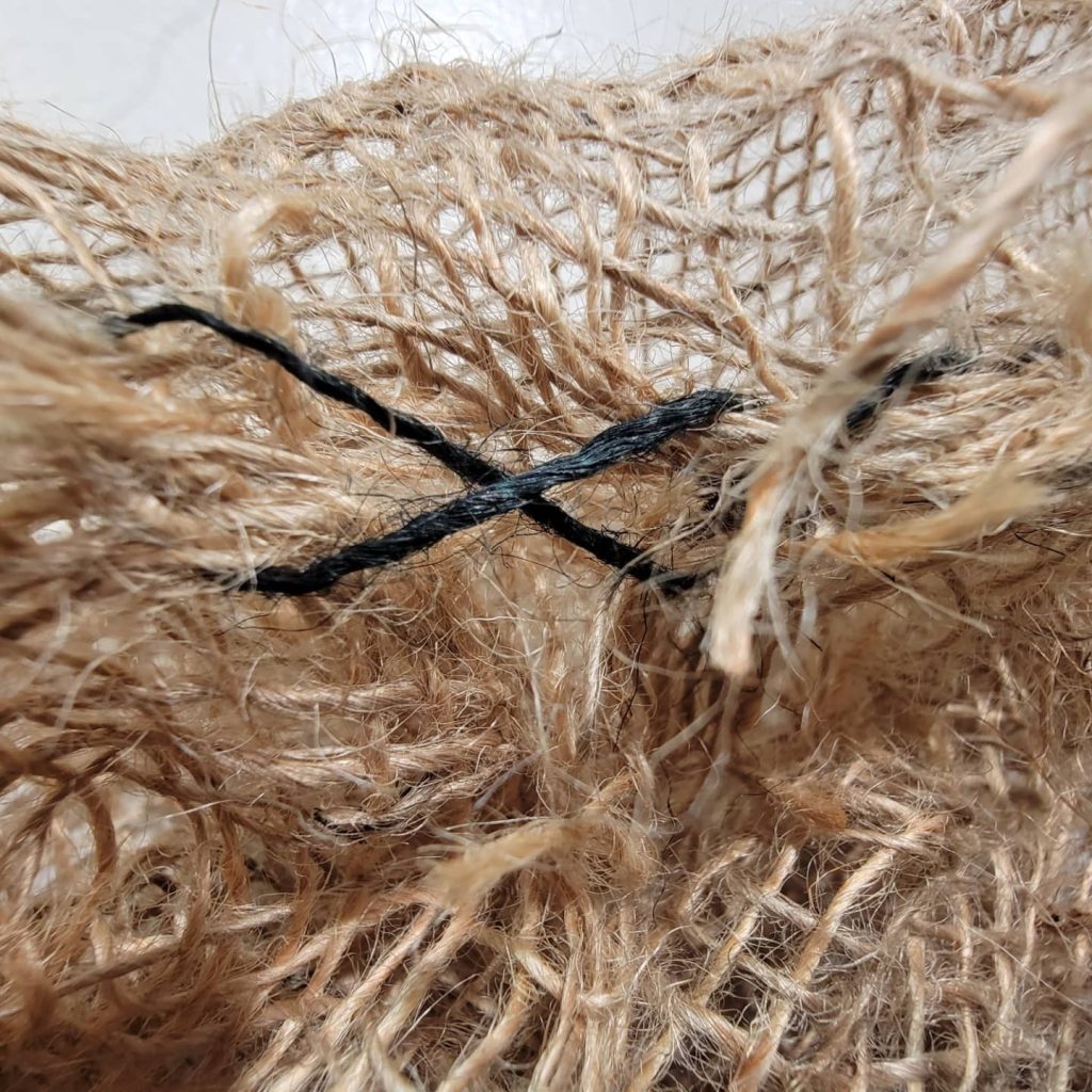 Detail of burlap piece stained with oxidation of steel stands out amongst the other golden pieces of burlap. Images courtesy of the artist.