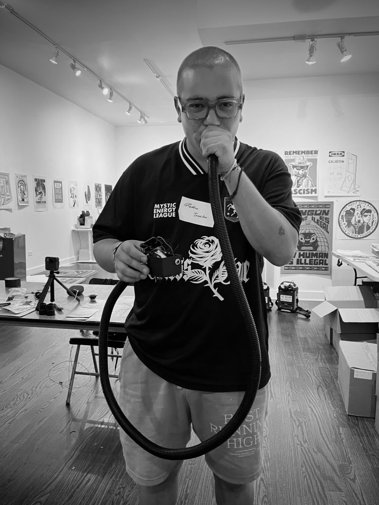 Black and white photos of workshop attendees with their sound instruments. Courtesy of Co-Prosperity.