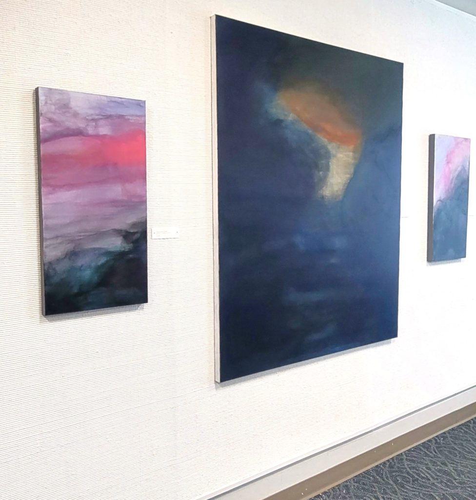 (from left to right): Hovering Over in My Sleep - Genesis 1:2; Dark Waters; Mark 4:35-41, ink, 2025. Three paintings arranged in a row on a light colored wall. All paintings are from Allena Marie Brazier solo show: WaterWays. Image courtesy of the artist.